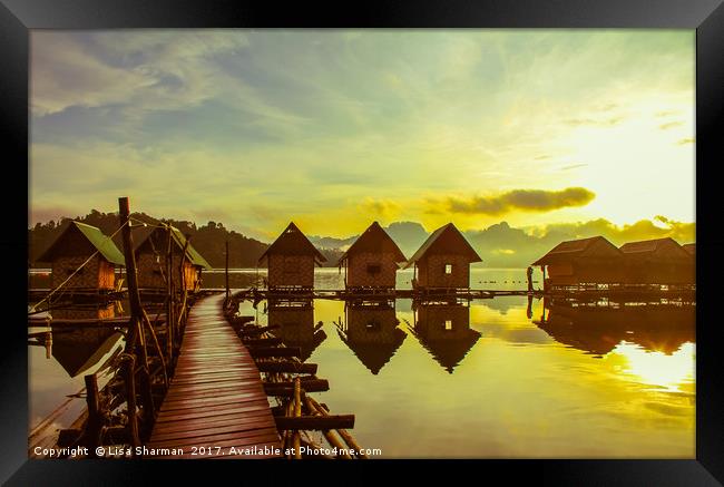 Sunrise over lake huts Framed Print by  