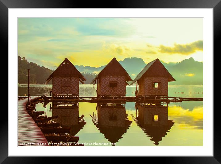 Sun rising over cute little wooden huts perched on Framed Mounted Print by  