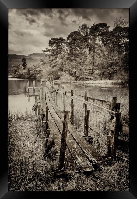 Old worn jetty into Derwent water Framed Print by Peter Scott