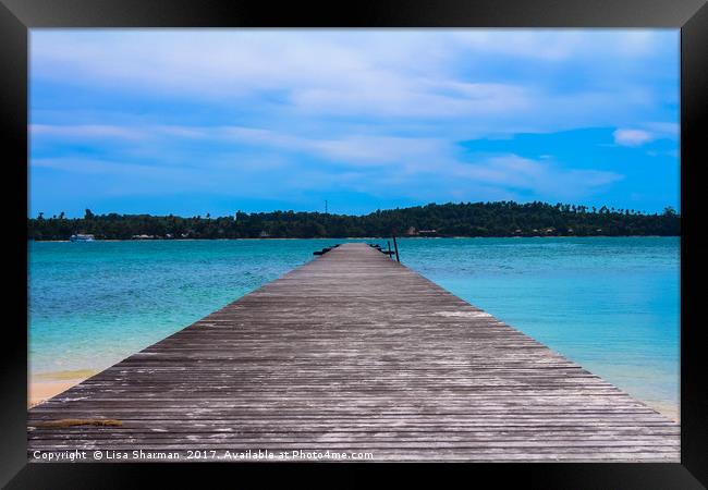 Wooden pier leading out to the sea Framed Print by  