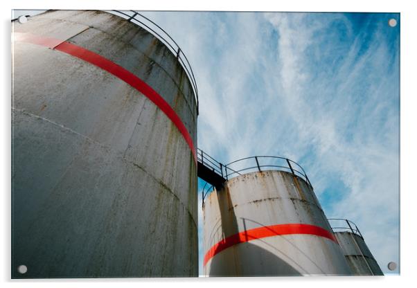Industrial fuel tanks against a blue sky Acrylic by Tom Radford