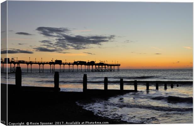 Silhouetted sunrise  of Teignmouth Pier and Groyne Canvas Print by Rosie Spooner