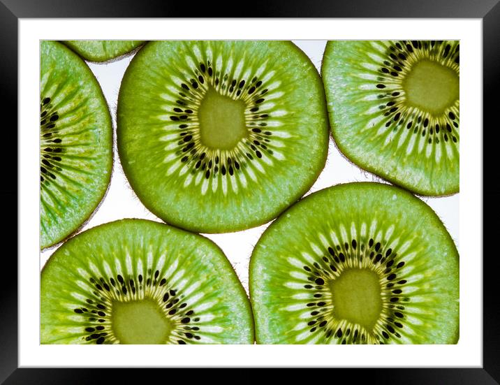 Green  kiwi fruit slices Framed Mounted Print by Chris Warham