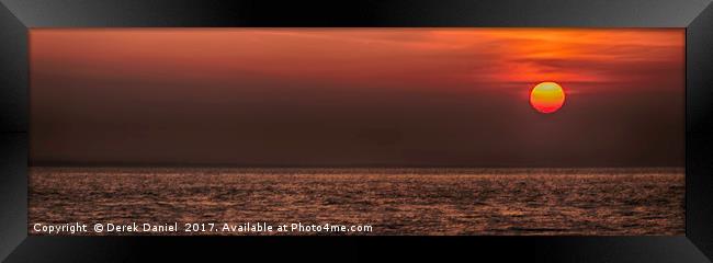 Rising sun at Peveril Point, Swanage Framed Print by Derek Daniel