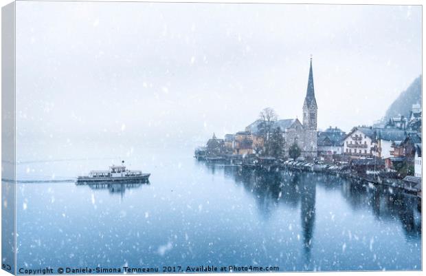 Hallstatt town and a boat under snowfall Canvas Print by Daniela Simona Temneanu