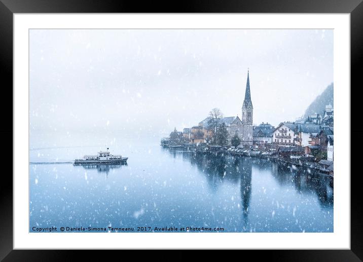 Hallstatt town and a boat under snowfall Framed Mounted Print by Daniela Simona Temneanu