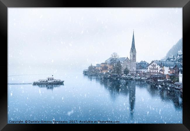 Hallstatt town and a boat under snowfall Framed Print by Daniela Simona Temneanu