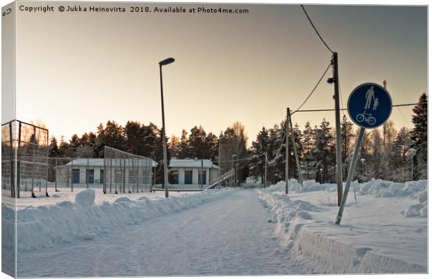 Snowy Path to the Town Canvas Print by Jukka Heinovirta