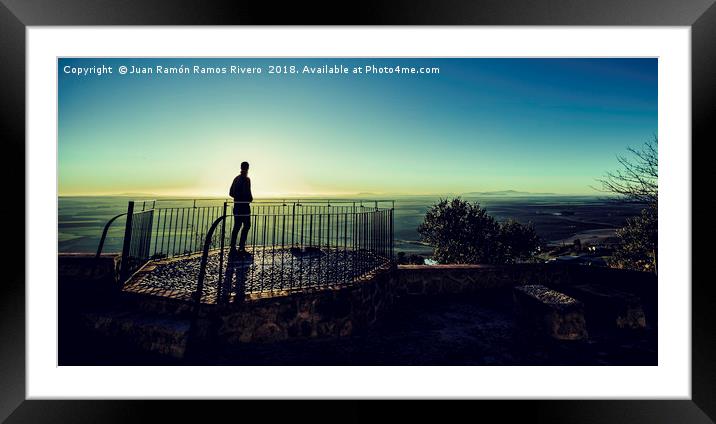 Silhouette of young boy watching sunrise Framed Mounted Print by Juan Ramón Ramos Rivero