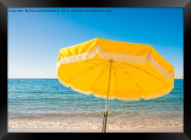 Giant yellow beach umbrella next to the ocean agai Framed Print by Alexandre Rotenberg