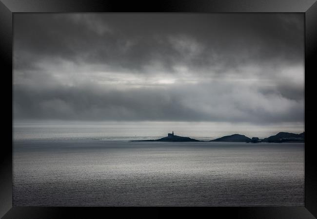 Mumbles lighthouse on a cloudy day. Framed Print by Bryn Morgan