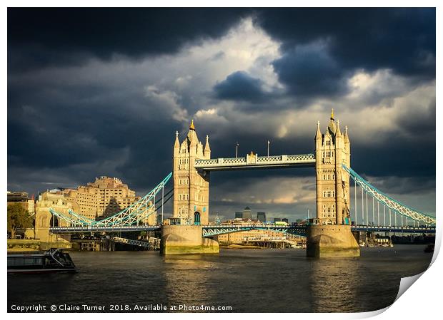 Tower bridge illuminated in a dark sky Print by Claire Turner