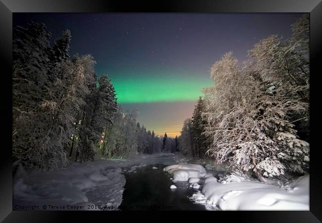 The Aurora Borealis dances over a wintered stream Framed Print by Teresa Cooper