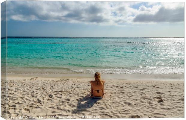 Woman relax in front of the Caribbean Sea in Aruba Canvas Print by Marco Bicci