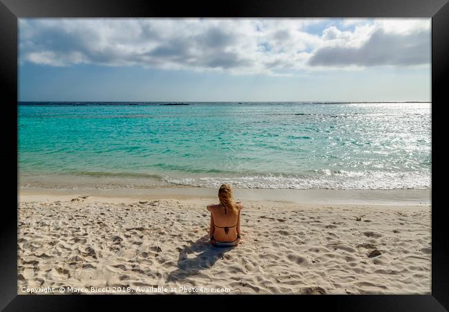 Woman relax in front of the Caribbean Sea in Aruba Framed Print by Marco Bicci