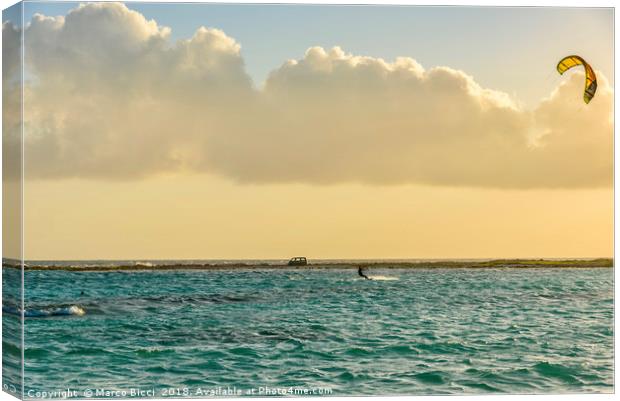 A man practices kitesurfing at sunset Canvas Print by Marco Bicci