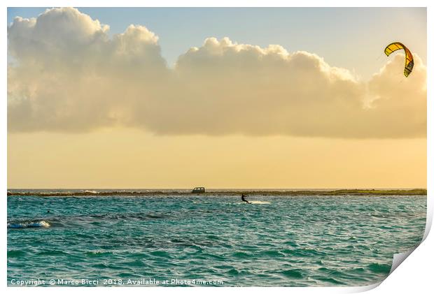 A man practices kitesurfing at sunset Print by Marco Bicci