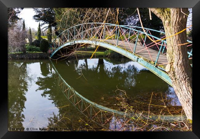 Footbridge with reflection. Framed Print by Clive Wells