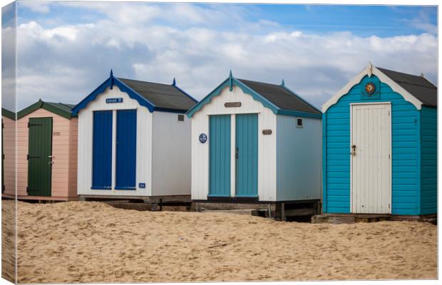Colourful Seaside Shelters Canvas Print by Kevin Snelling