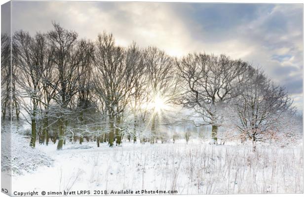 Snow covered rural trees with early morning sunris Canvas Print by Simon Bratt LRPS