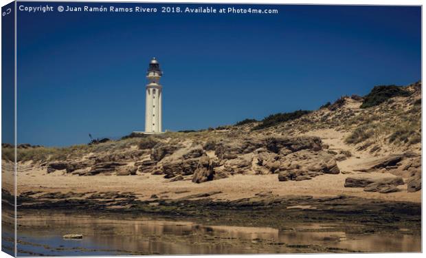 Lighthouse on the beach Canvas Print by Juan Ramón Ramos Rivero