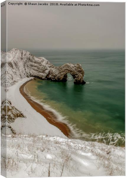 Durdle Door covered in snow  Canvas Print by Shaun Jacobs