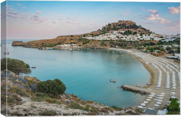 View of Lindos over Lindos Bay Canvas Print by Martin Williams