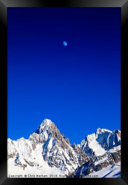 Moon above the French Alps against a deep blue sky Framed Print by Chris Warham