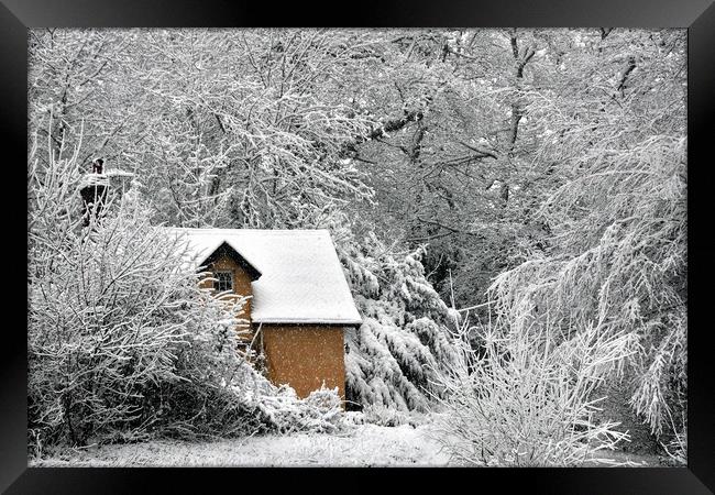 A cottage in the snow Framed Print by Jeremy Fennell