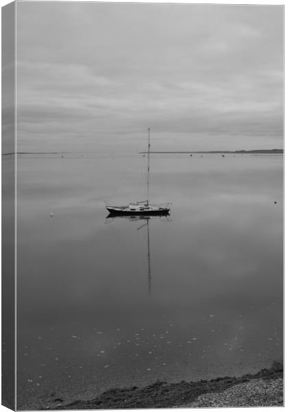 A sailing boat on calm water. Canvas Print by Rob Evans