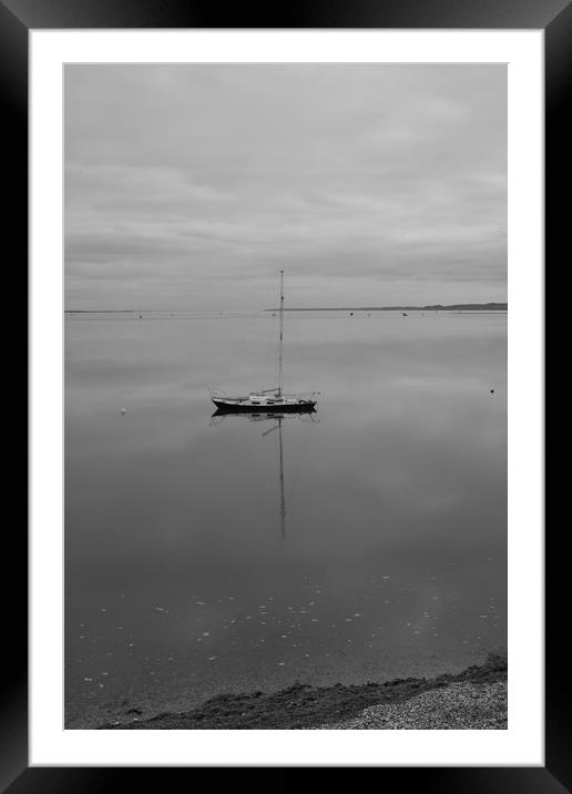 A sailing boat on calm water. Framed Mounted Print by Rob Evans