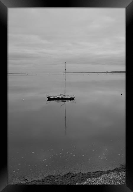 A sailing boat on calm water. Framed Print by Rob Evans