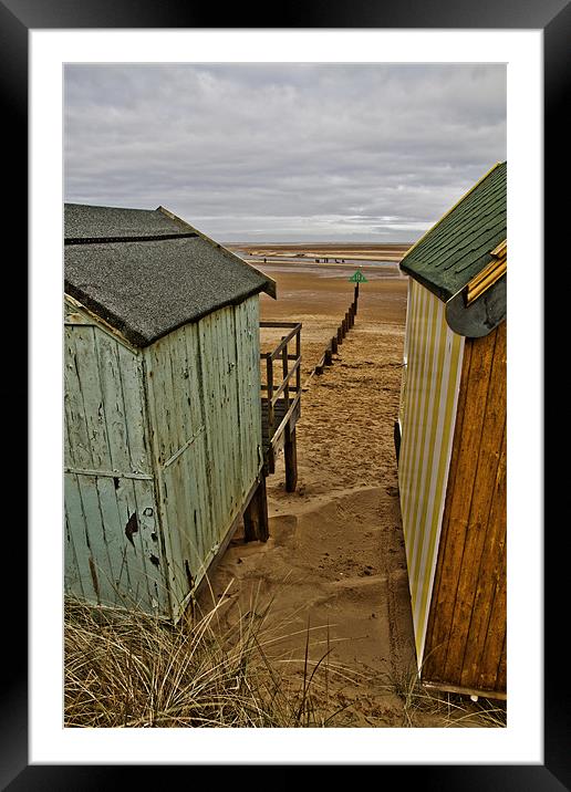 View through the huts at Wells Framed Mounted Print by Paul Macro