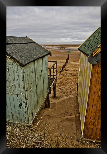 View through the huts at Wells Framed Print by Paul Macro