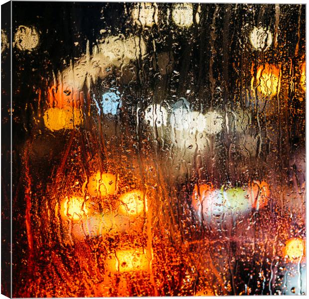 Raindrops on street window Canvas Print by Alexandre Rotenberg