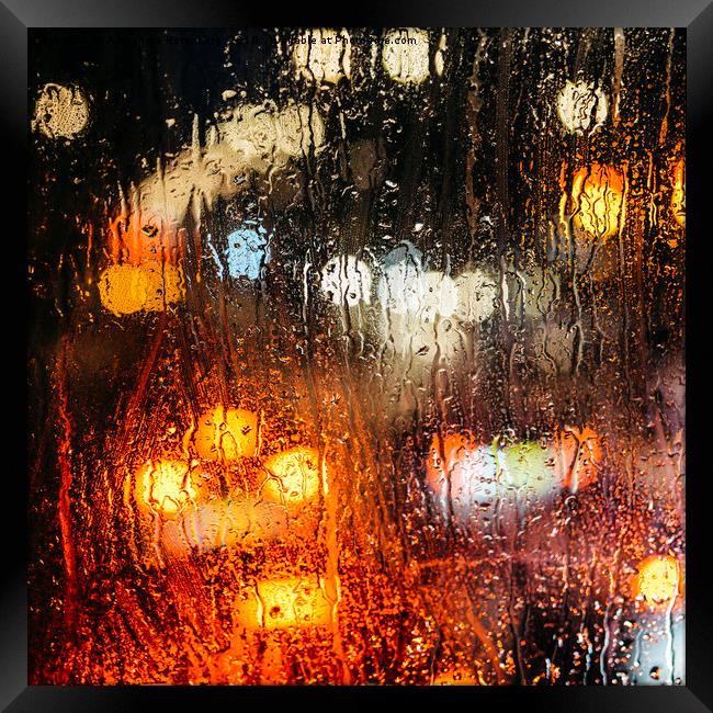 Raindrops on street window Framed Print by Alexandre Rotenberg