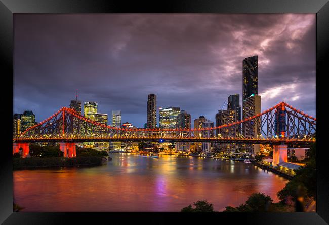 Story Bridge lit up after dark with Brisbane city  Framed Print by Andrew Michael