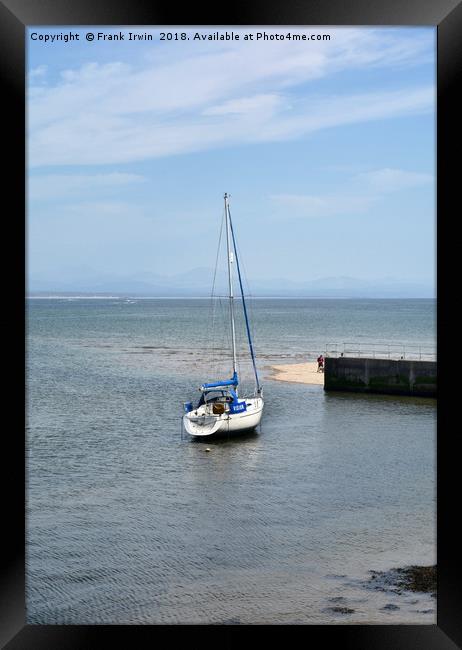 A yacht lies at anchor in Abersoch Harbour Framed Print by Frank Irwin