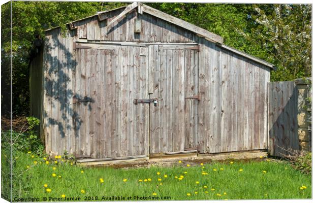 Weathered wooden out building garage in the Englis Canvas Print by Peter Jordan