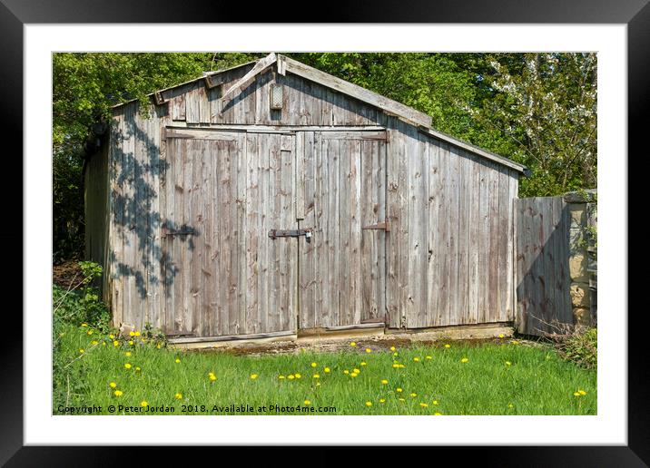 Weathered wooden out building garage in the Englis Framed Mounted Print by Peter Jordan