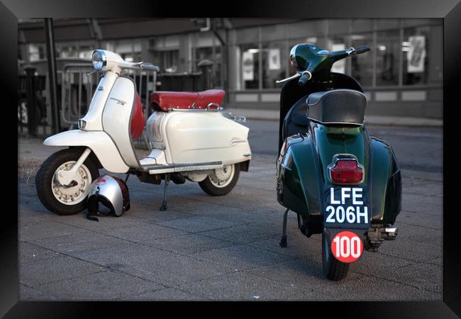 Vespa Sprint and Lambretta Li in town Framed Print by Donnie Canning