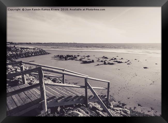 Wooden jetty over the breakwater at low tide Framed Print by Juan Ramón Ramos Rivero
