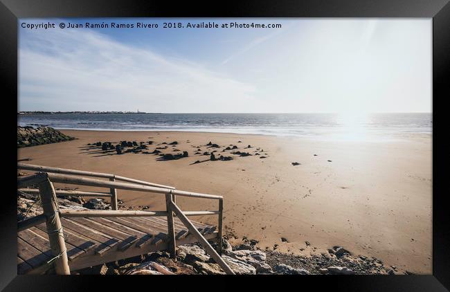 Wooden jetty over the breakwater at low tide Framed Print by Juan Ramón Ramos Rivero