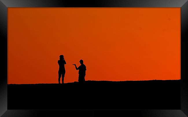 Silhouettes in the desert Framed Print by Simon Curtis