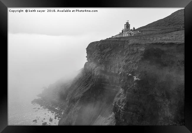 Whitby Lighthouse as the fog rolls in Framed Print by keith sayer