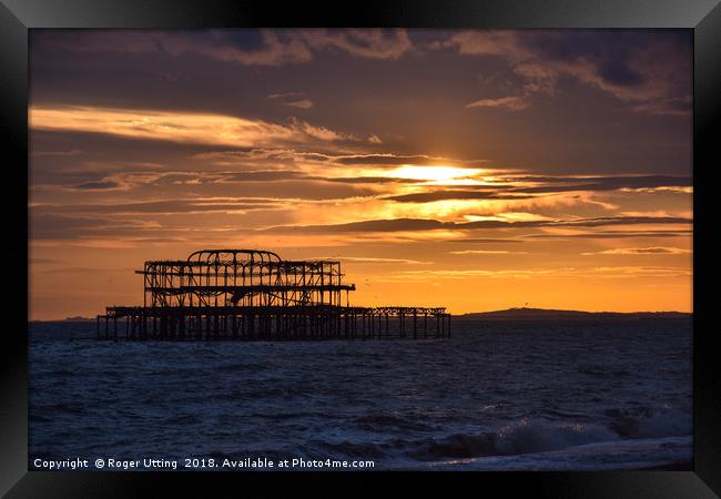 West Pier at sunset Framed Print by Roger Utting