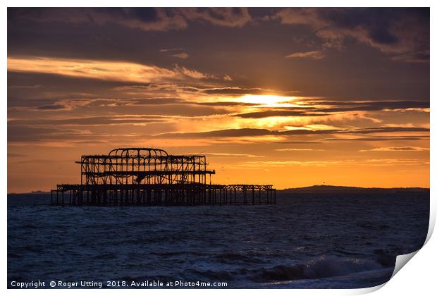 West Pier at sunset Print by Roger Utting