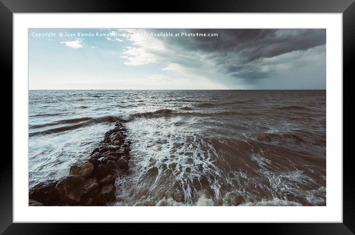 Rocks in the sea with storm sky on the beach Framed Mounted Print by Juan Ramón Ramos Rivero