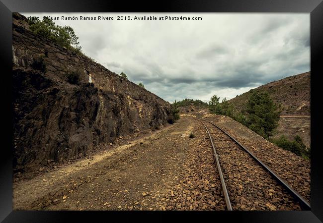 Old train tracks between mountains on a cloudy day Framed Print by Juan Ramón Ramos Rivero