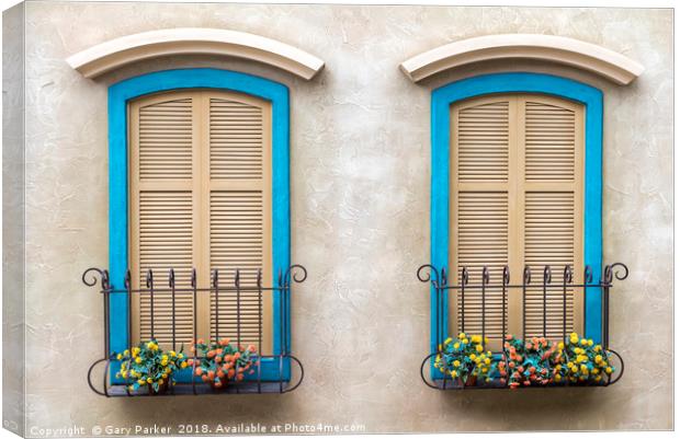 Two quaint windows, with bright blue frames Canvas Print by Gary Parker